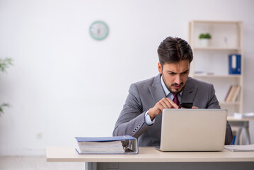 Young male employee working in the office