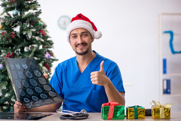 Young male doctor celebrating Christmas at the hospital