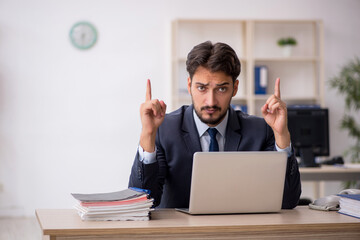 Young male employee working in the office