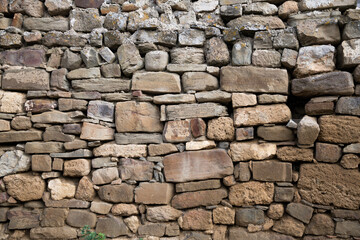 Close-up of a fragment of an old natural white limestone wall.