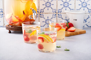 Summer sangria punch in a pitcher and glasses