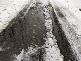 melted dirty snow on city streets photo in the daytime.