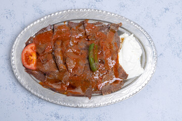 İskender Kebap as a traditional meat food of turkish cuisine with sauce yogurt and butter