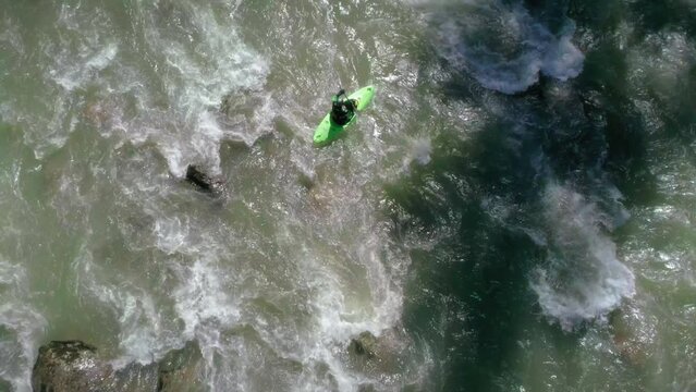 Overhead Aerial of Adventurous Kayaker Paddling Whitewater Rapids