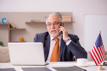Old male employee working from home during pandemic