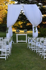 white chairs in a garden for a wedding