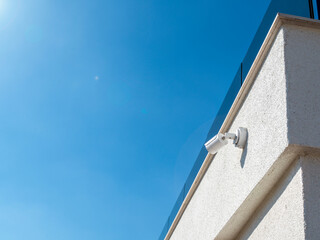 Security cctv camera mounted on home building. Big Brother watching you concept with copy space