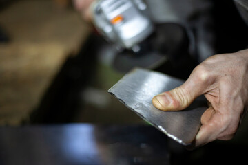 Metal cutting. Grinding steel. Work as a grinder. Sparks from friction. Men's work. Creating a...