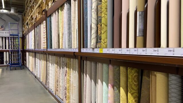 Rows of wallpaper rolls in a hardware store