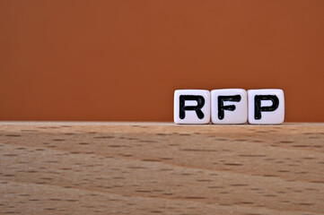 Word cubes lined up with the letters RFP written on it. It is an abbreviation for Request for...