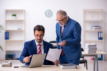 Two male colleagues working in the office