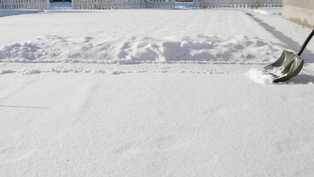 Shoveling Snow With A Shovel In Sunny Weather. Guy Shoveling Snow