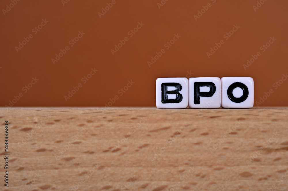 Poster word cubes lined up with the letters bpo written on it. it is an abbreviation for business process o