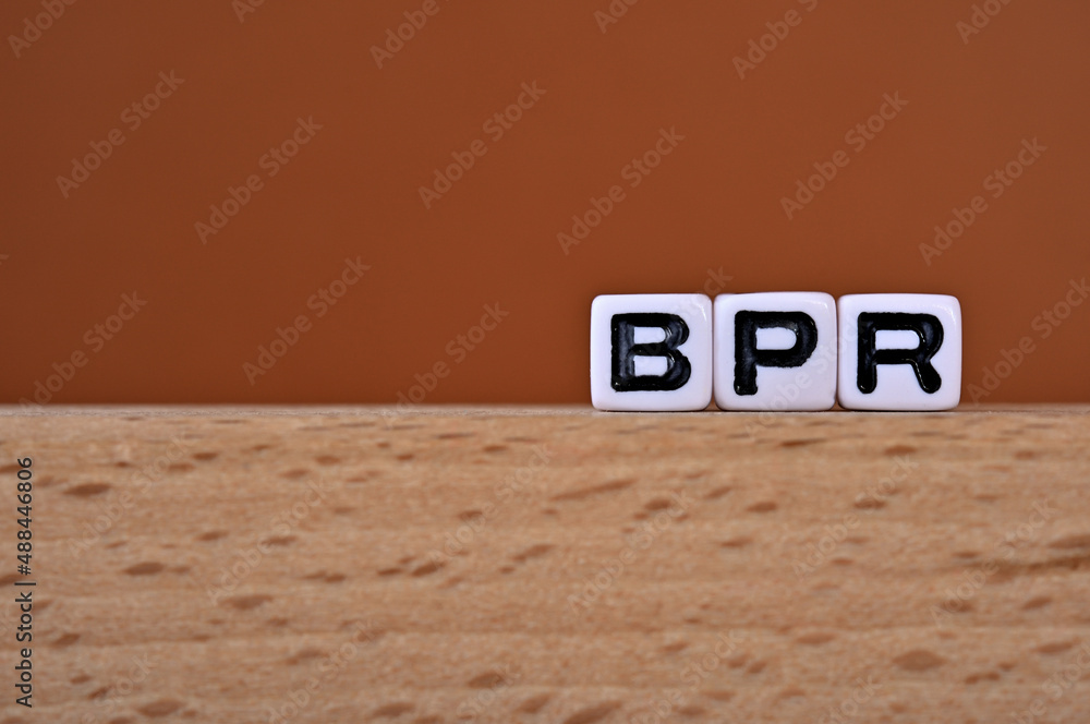 Poster word cubes lined up with the letters bpr written on it. it is an abbreviation for business process r
