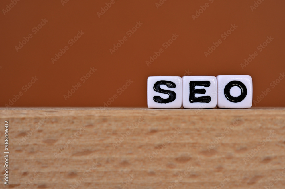Poster word cubes lined up with the letters seo written on it. it is an abbreviation for search engine opti