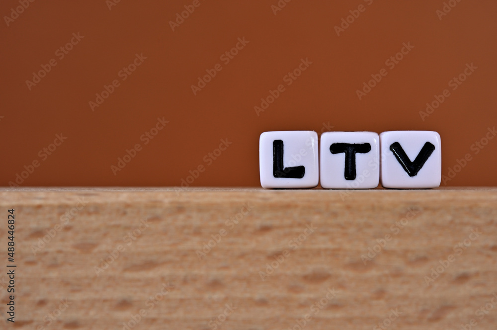 Poster word cubes lined up with the letters ltv written on it. it is an abbreviation for life time value. c