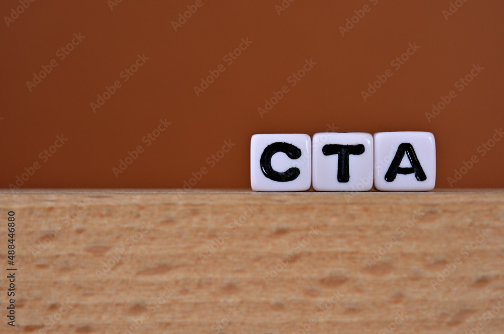 Poster word cubes lined up with the letters cta written on it. it is an abbreviation for call to action. co