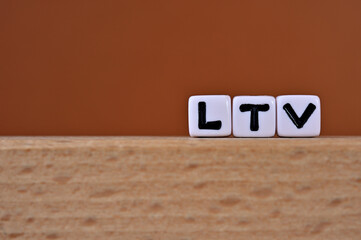 Word cubes lined up with the letters LTV written on it. It is an abbreviation for Life Time Value....