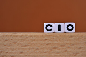 Word cubes lined up with the letters CIO written on it. It is an abbreviation for chief information officer. Copy space available.