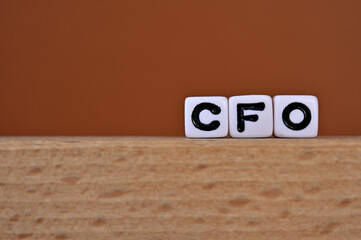 Word cubes lined up with the letters CFO written on it. It is an abbreviation for Chief Financial...