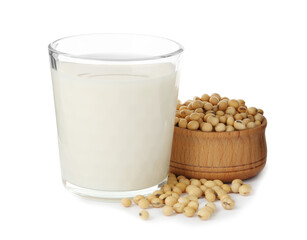 Glass of fresh soy milk and bowl with beans on white background