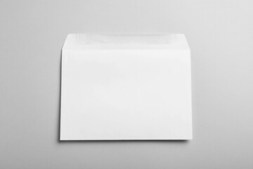 White paper envelope on light grey background, top view