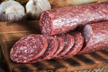 close-up of salami on a cutting board with cut pieces