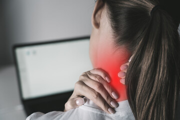 Woman suffering from neck pain after working on laptop