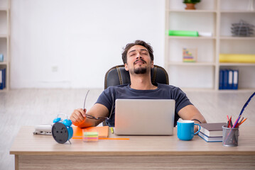 Young male designer working in the office