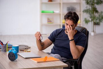 Young male designer working in the office