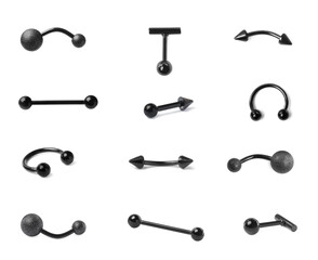 Set with different piercing jewelry on white background
