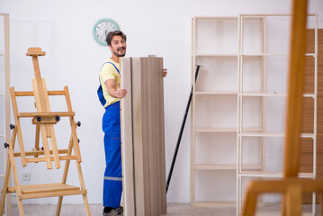 Young male carpenter working at home