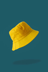 yellow bucket hat, blue background