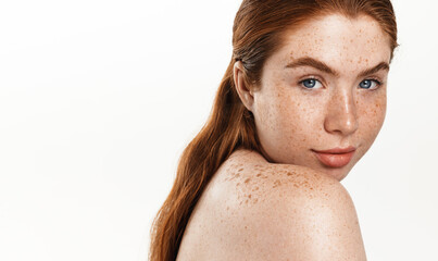 Body and Spa concept. Beautiful redhead woman plus size, looking behind shoulder and smiling....