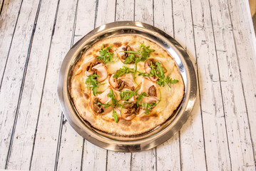 pizza with black truffle sauce and mushrooms. A very simple recipe for truffled pizza