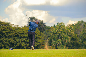 Man Playing Golf on Beautiful Day Green Golf Course.