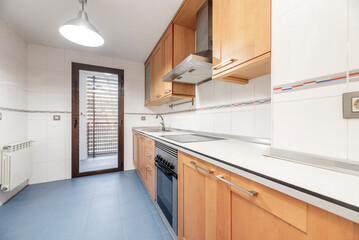 full kitchen with white wood countertops with cherry wood cabinets and stainless steel appliances