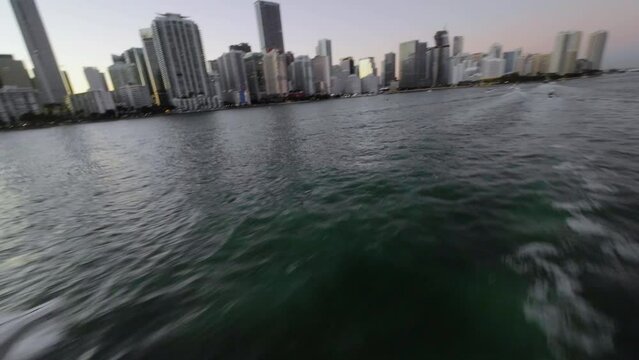FPV drone shot around a boat, with Brickell, Miami background- POV aerial view