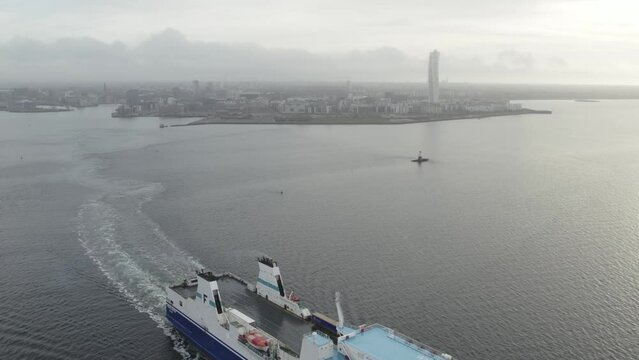 Ship leaving port in Malmoe, turning torso in background