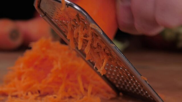 grate carrot on grater slow motion 4k