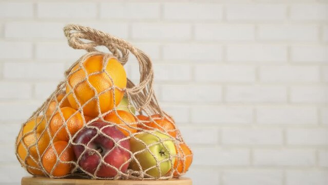 Alternative buying in eco bag. A view of fruit meal in an eco string mesh in the room.