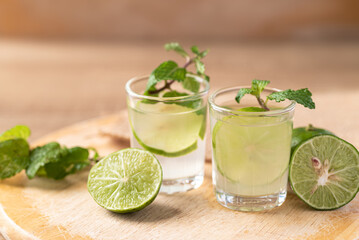Lime juice with fresh lime fruit and mint leaf on wooden background, Fresh drink in summer season