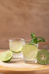 Lime juice with fresh lime fruit and mint leaf on wooden background, Fresh drink in summer season