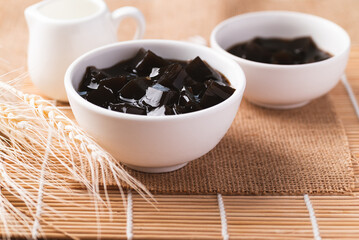 Grass jelly or herb jelly, dessert in Southeast Asia made from plant eating with syrup, bubble tea or other drinks
