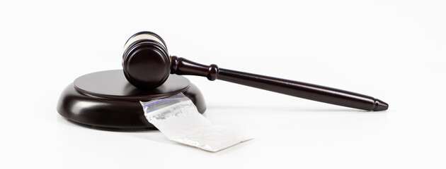 Judge gavel with cocaine in a plastic bag on a white background with copy space