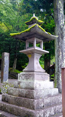  Rustic stone lanterns to moss covered rocks in shrine at Narai juku. Lantern are a symbol of illumination, a guiding light, can be saved from darkness