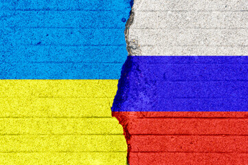 The Russian and Ukrainian flags are printed on the cracked floor. Ukraine crisis. Border conflict....