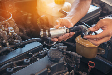 Close up Man hands fixing Car machinery vehicle mechanical service. Mechanic man hands repairing...