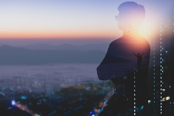 A young businessman wearing a suit and eyeglasses stands looking at the future where nature is...