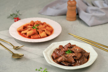Korean Rice Cakes in Black Soybean Sauce Jjajang Tteokbokki or Jjajangmyeon Topokki with Topkki in Red Sauce